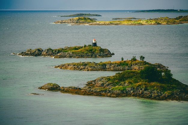 Photo of sea hills lighthouse sky in Norway on summer