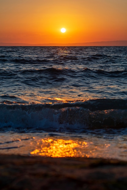 Photo of a sea sunset. Seascape. Sunset on the sea. The sea with waves.