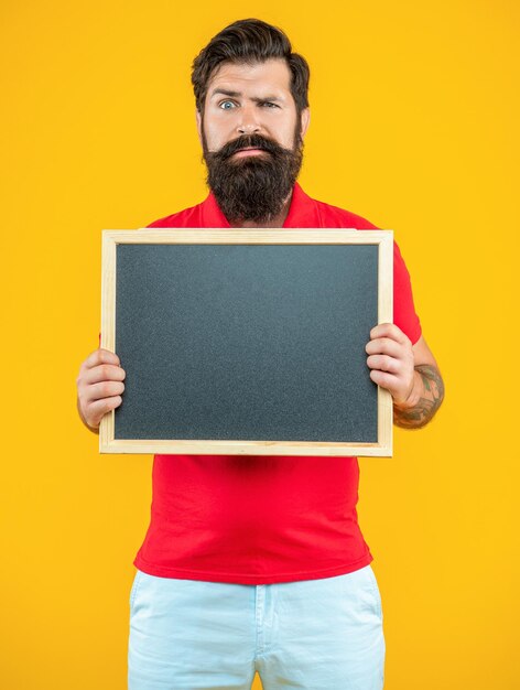 Photo of serious man with announcement on blackboard man with announcement