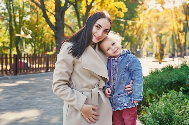 photo session of mother with daughter in autumn park