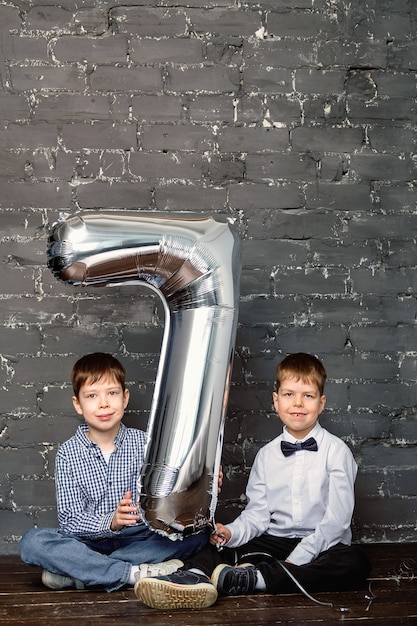 photo session with a ball 7 years old. Silver ballon with number 7.