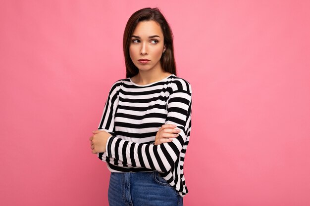 Photo shot of cute attractive pretty young sad upset brunette woman wearing casual striped long sleeve