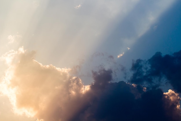 A photo of a sky with clouds and sun rays