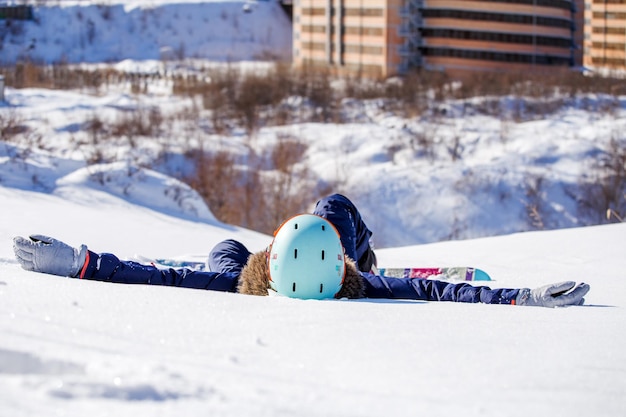 Photo of sporty woman with snowboard lying