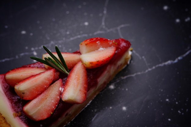 Photo of strawberry cake on a black background