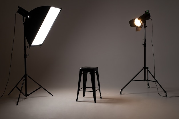 Photo studio with lighting equipment. light scheme and chair. The concept of selection and casting. Job recruitment advertisement.