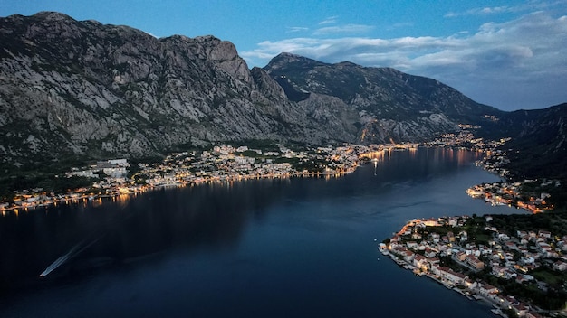 Photo of sunset in the boko kotor bay night city lights