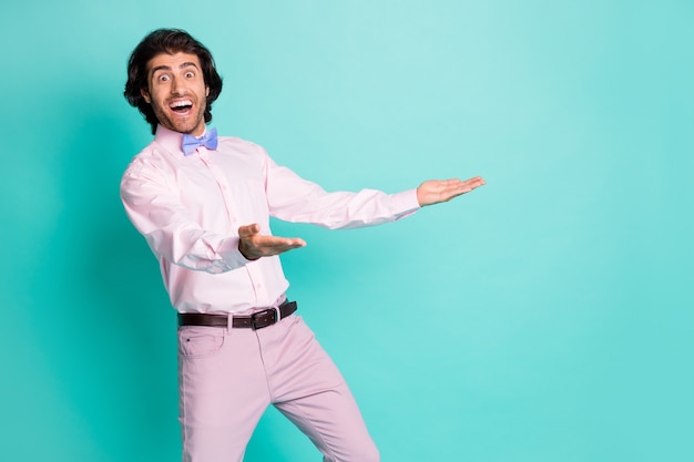 Photo of surprised bristle curly man dressed pink outfit open mouth open arms isolated turquoise color background