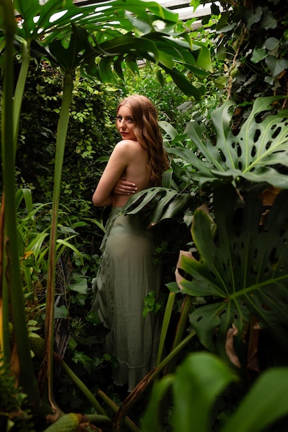 Photo photo of sweet adorable woman naked shoulders shell necklace applying natural cream outdoors tropical forest