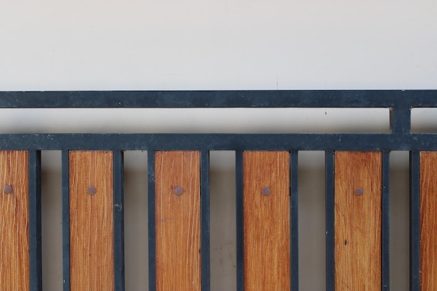 Photo of a symmetrical brown and black iron picket fence