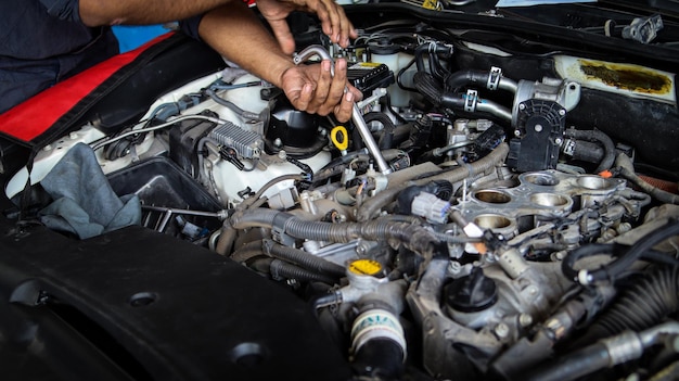 Photo that's need to be recharged process of repairing car after accident man working with engine