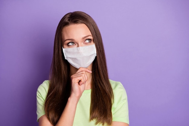 Photo of thoughtful woman touch chin finger covid protection thoughts wear medical mask isolated violet colored background