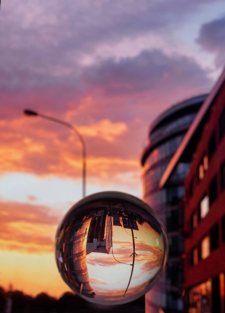 Photo through a glass ball on a Stones Enchanting sunset and modern buildings in Klaipeda Lithuania