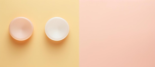 Photo of two white bowls on a vibrant yellow and pink background with copy space