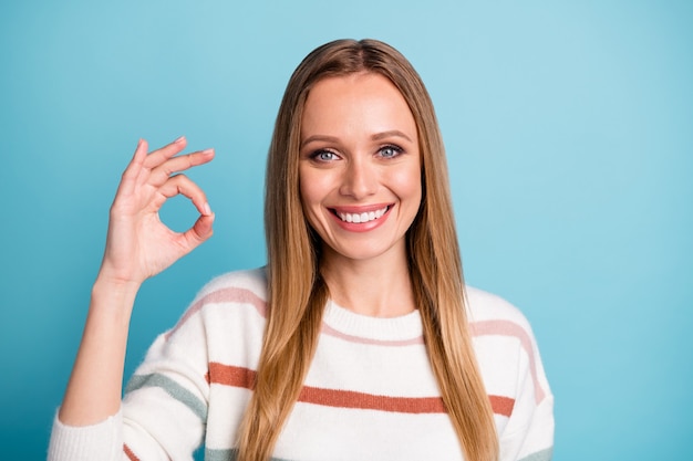 Photo of white cheerful positive pretty sweet woman smile toothy showing you ok sign expressing satisfaction on face about result isolated pastel color wall