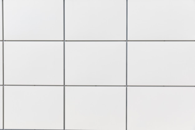 Photo of a white wall of a house with squares