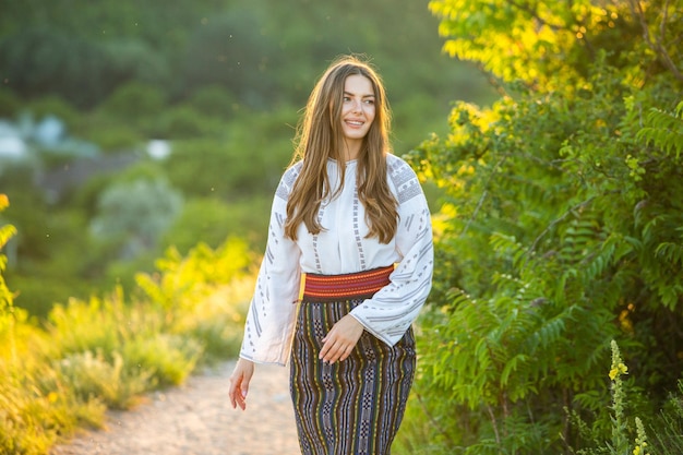 Photo with young girl wearing Romanian traditional blouse in the country Authentic national costume