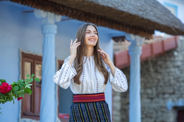 Photo with young girl wearing Romanian traditional blouse in the country Authentic national costume