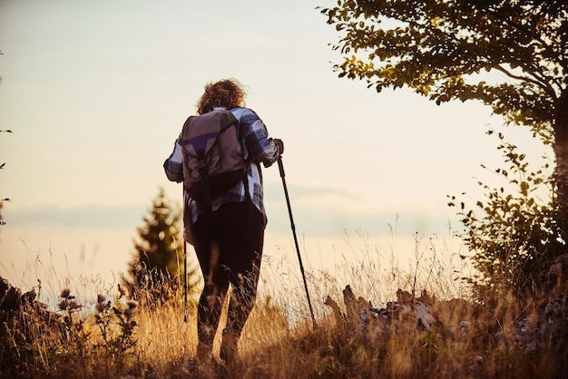 A photo of a woman hiking with a backpack Selective focus