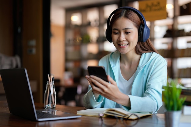 Photo of woman wearing headphones and using mobile phone for online learning educational course or training seminar education online concept