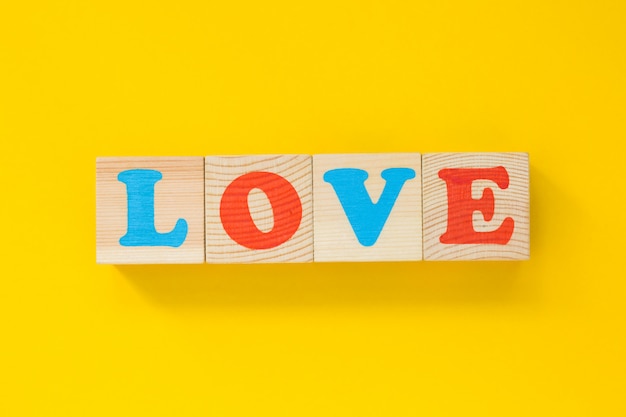 Photo of wooden children's cubes on yellow.