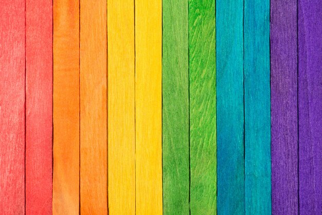 Photo of wooden colorful rainbow background made of wooden planks with copy space for text