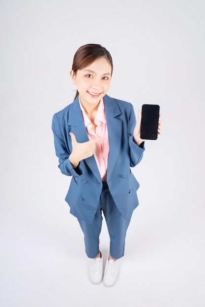 Photo of young Asian business woman using smartphone