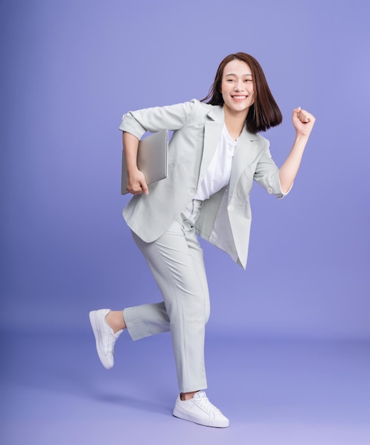 Photo of young Asian businesswoman on background