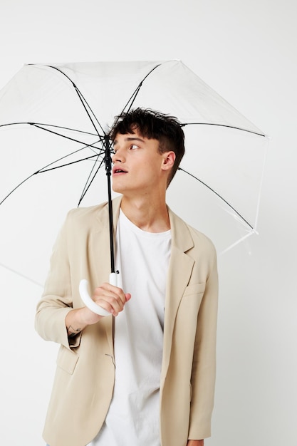 Photo young boyfriend holding an umbrella in the hands of posing fashion light background unaltered