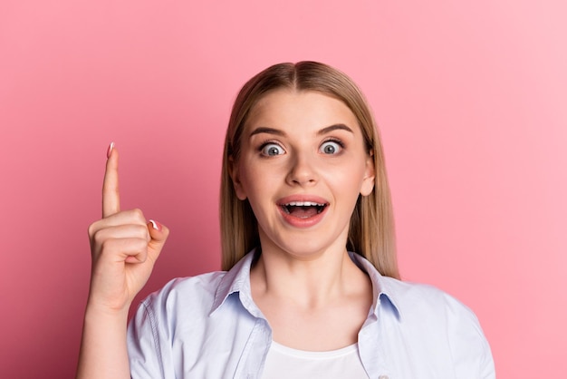 Photo of young girl indicate finger idea plan choice candid smart isolated over pink color background