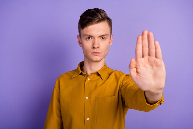 Photo of young guy show hand no stop refuse rejection symbol block enough isolated over violet color background