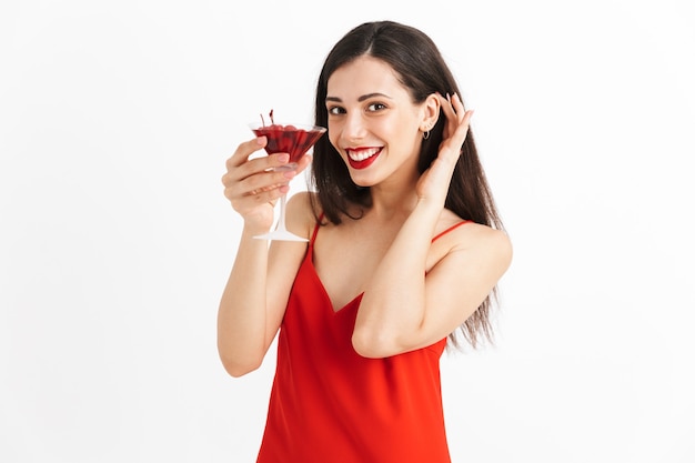 Photo of young happy excited woman posing isolated drinking cocktail.