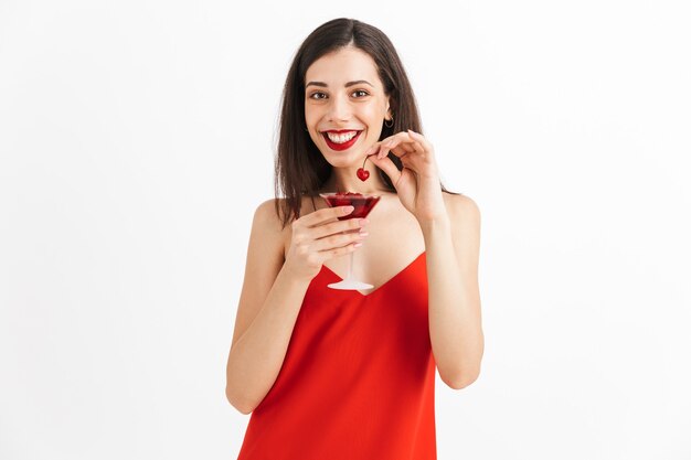 Photo of young happy excited woman posing isolated drinking cocktail.