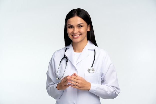 Photo of young happy woman professional wearing suit smiling friendly while posing to the camera isolated on white color background