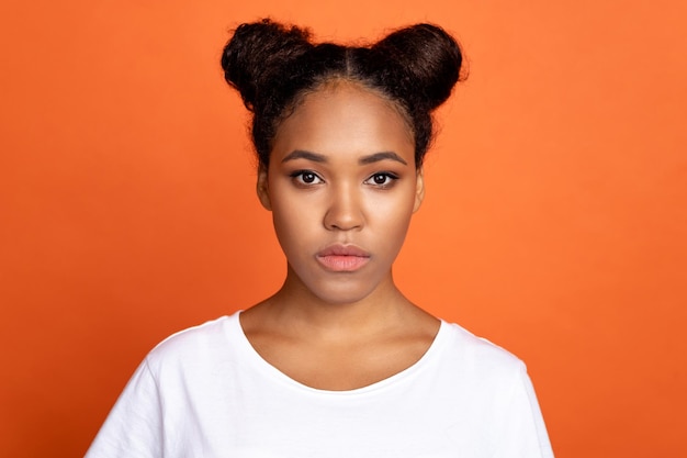 Photo of young lovely african woman confident clever wear casual clothes isolated over orange color background