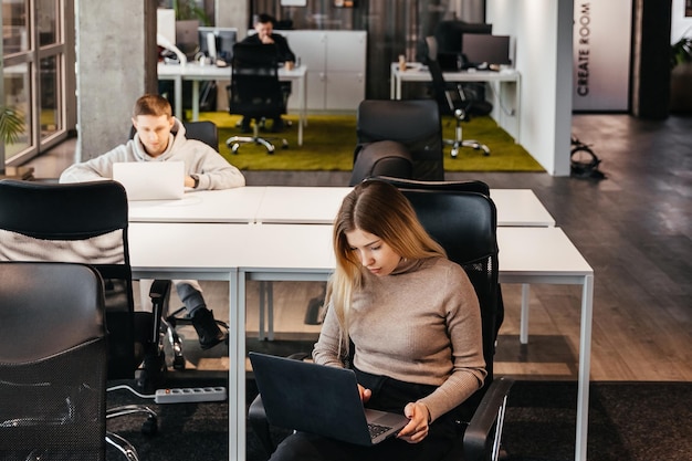 photo of young people working at a computer in a modern coworking office