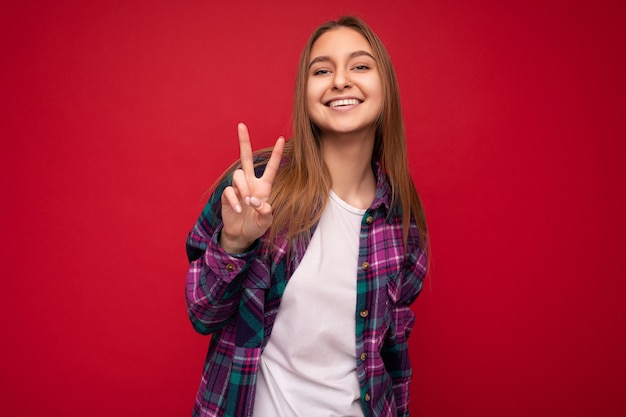 Photo of young positive happy smiling beautiful woman with sincere emotions wearing stylish clothes