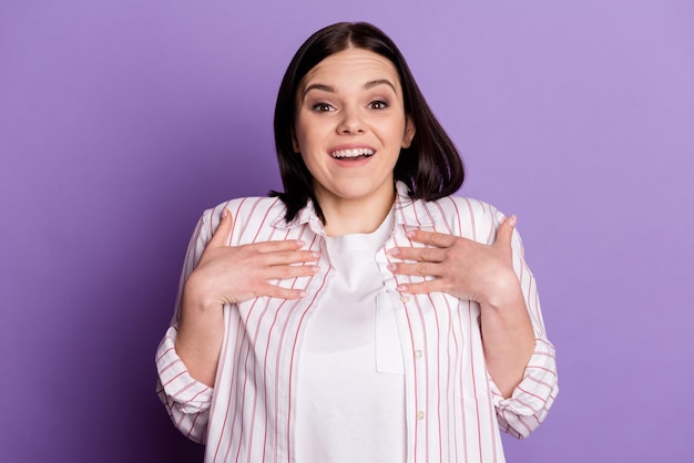 Photo of young pretty girl hands touch chest amazed shock unexpected questioned isolated over violet color background