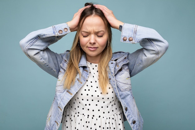 Photo of young sad upset attractive blonde woman with sincere emotions wearing jean blue jacket