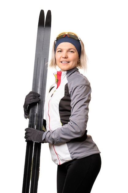 Photo of young sportswoman with skis on empty white background