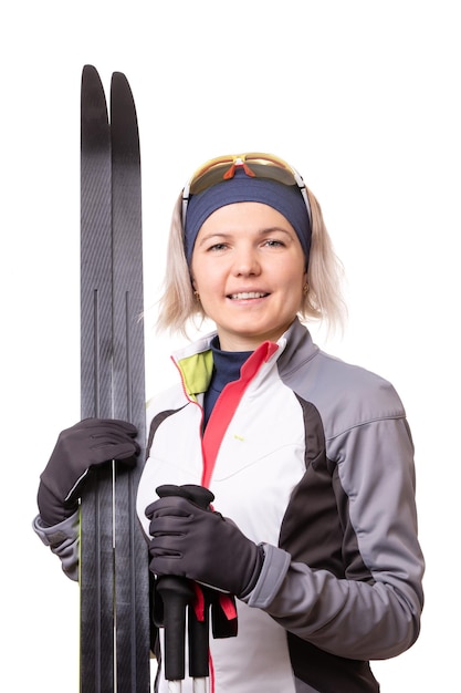 Photo of young sportswoman with skis on empty white background