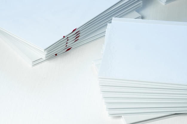 Photobooks with clean empty white covers on the table closeup