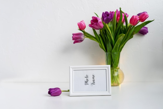 Photofame mock up on table with vase with tulips