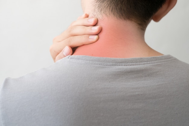 Photograph of a man from the back with pain and neck injury