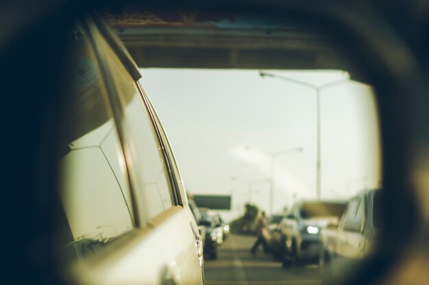 Photograph through the rear view mirror of the traffic behind the car.