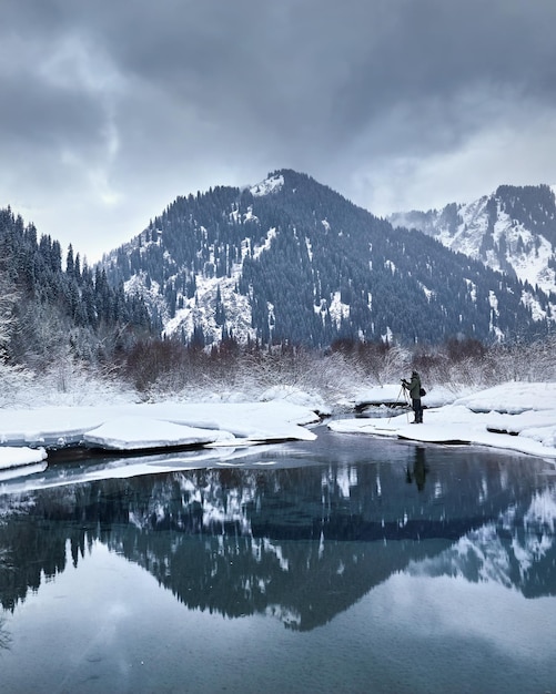 Photographer in epic mountains at winter