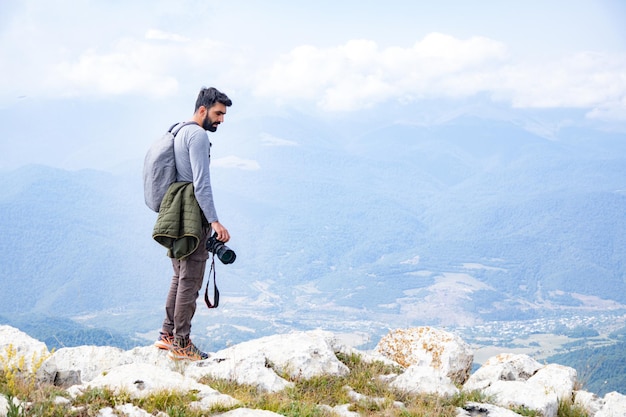 Photographer holding the camera in mountains