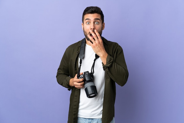 Photographer man on isolated purple surprised and shocked while looking right