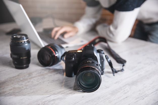 Photographer man with camera on desk