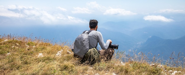 Photographer on mountain Nature photographer taking photo